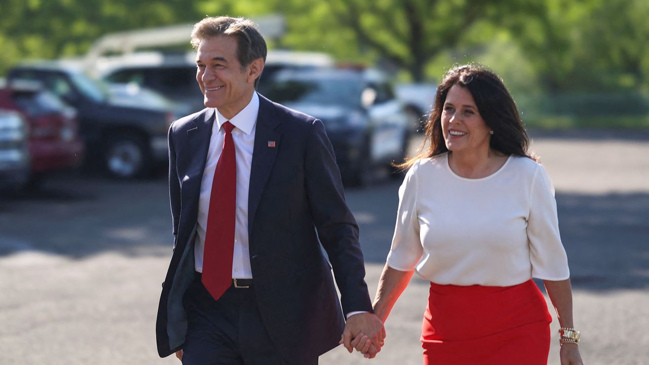 Pennsylvania Republican US Senate candidate Dr. Mehmet Oz and his wife, Lisa Oz, arrive to cast their vote, in Bryn Athyn, Pennsylvania, on May 17, 2022.