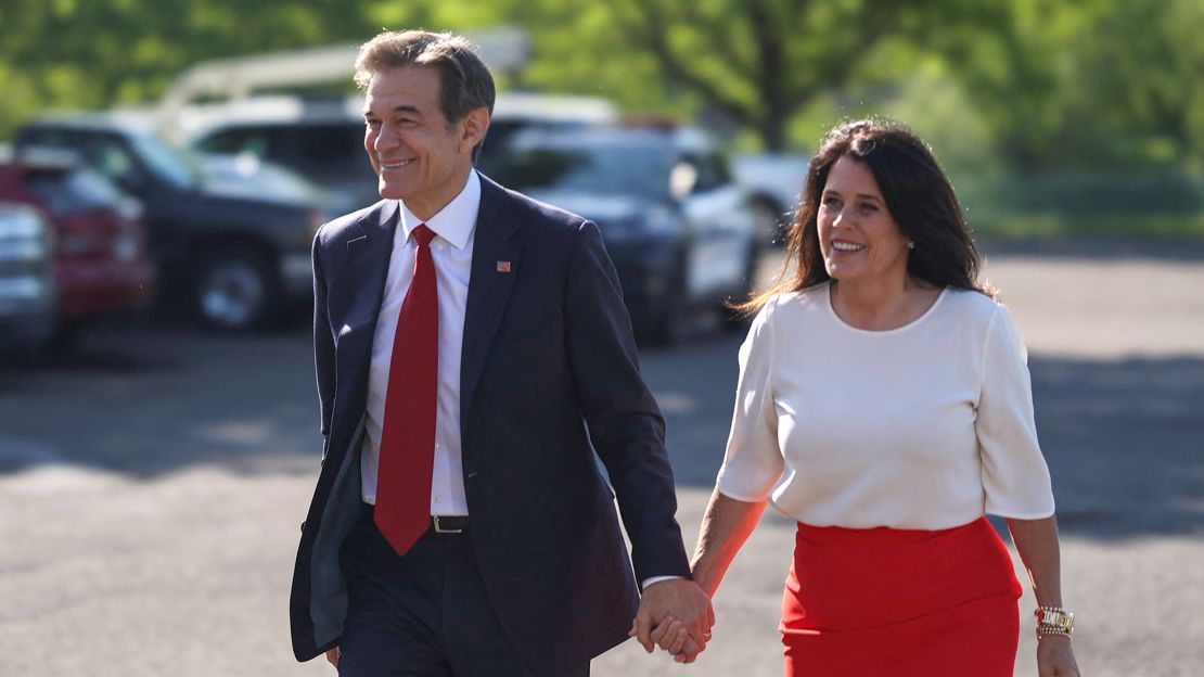 Mehmet Oz and his wife Lisa Oz arrive to cast their vote in Pennsylvania's Republican primary on May 17, 2022. REUTERS/Hannah Beier

