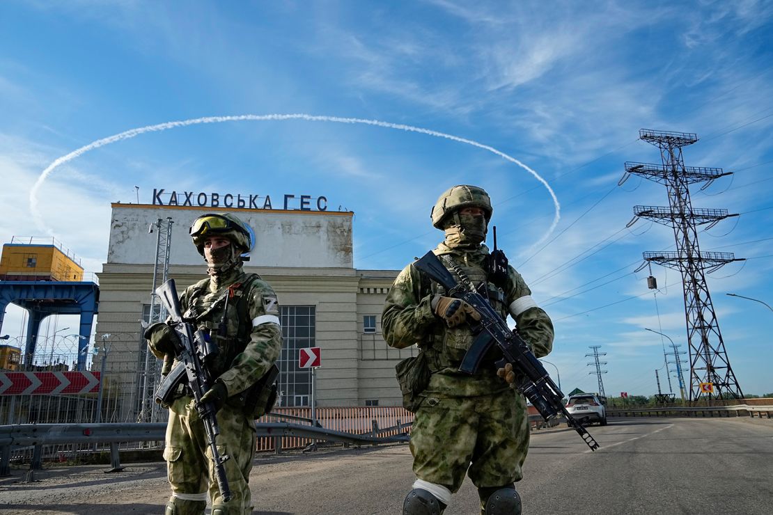 Russian troops guard an entrance of the Kakhovka power plant on the Dnieper River in southern Ukraine on May 20, 2022.