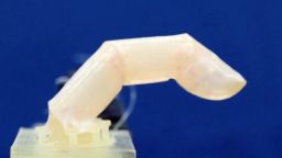 A robotic finger built with living humanlike skin can bend and repel water.