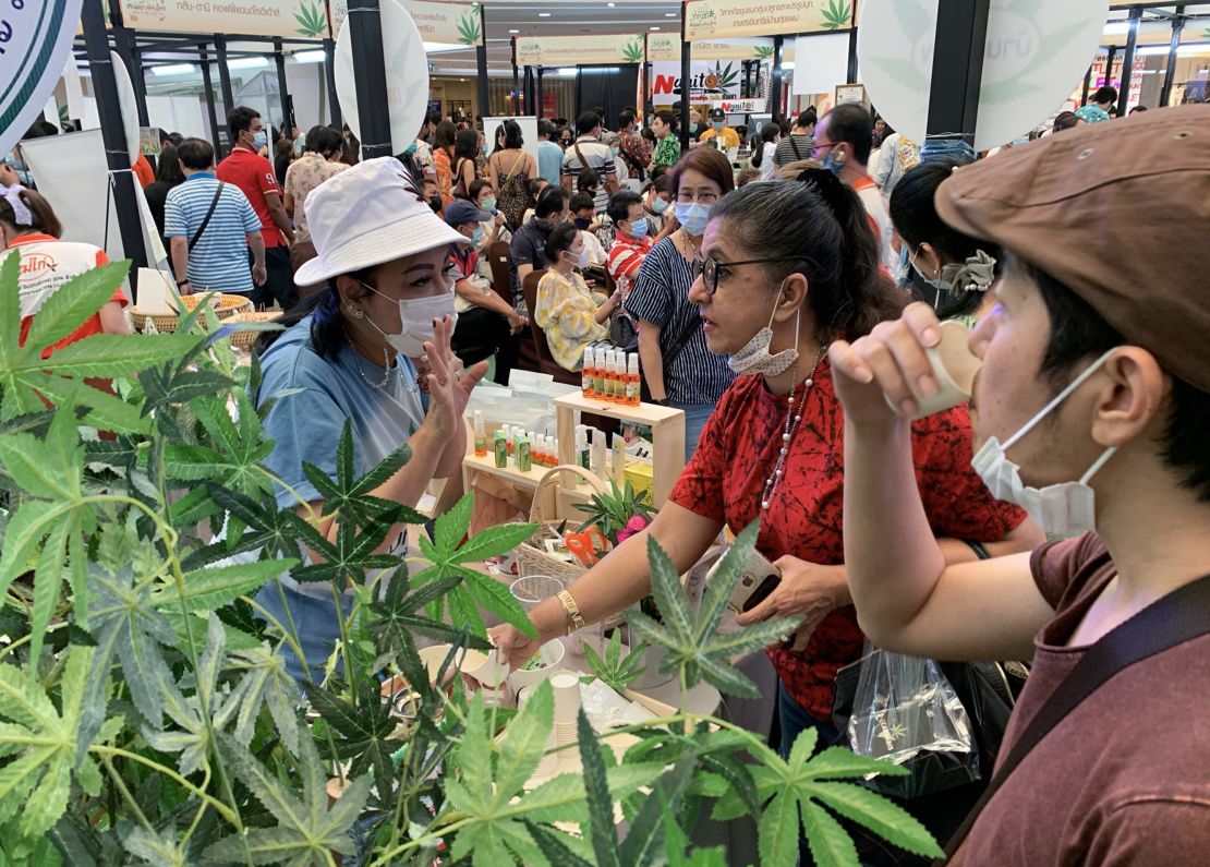 People drink tea containing cannabis leaves at the "Ganja and Thai Traditional Medicine in the City" trade fair in Bangkok in 2021.