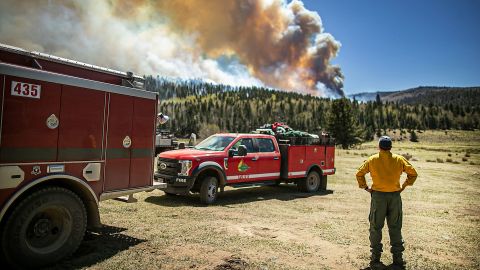 The Elk Creek fire department from Colorado watches the fire blaze across a ridgeline near the Taos County line as firefighters from all over the country converge on Northern New Mexico to battle the Hermit's Peak and Calf Canyon fire on May 13, 2022. (Jim Weber)