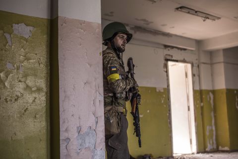 A Ukrainian soldier takes cover during heavy fighting at the front line in Severodonetsk, Ukraine, on Wednesday, June 8.