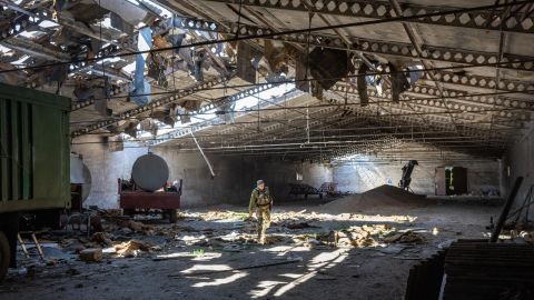 A Ukrainian army officer inspects a grain warehouse shelled by Russian forces on May 6, near Kherson.