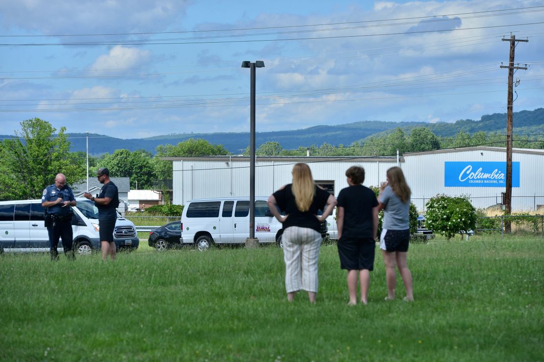 A Washington County Sheriff's Office deputy talks to bystanders following a shooting in Smithsburg, Maryland, on Thursday, June 9, 2020.