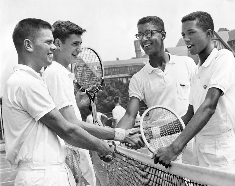 Ashe, far right, shakes hands with opponents at the Eastern Junior Tennis Championships in 1959. Ashe was born in Richmond, Virginia, in 1943 and began playing tennis at an early age. He first tested his skills on a Blacks-only playground in the city.