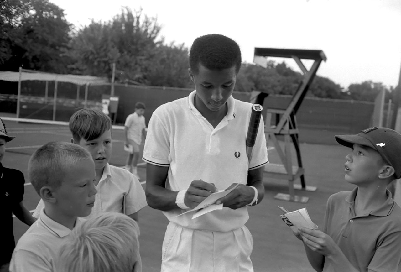 Ashe signs autographs for children in 1965.