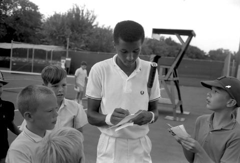 Ashe signs autographs for children in 1965.