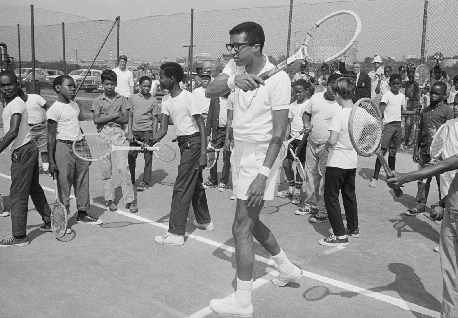 Ashe works with children during a tennis clinic in Washington, DC, in 1968.