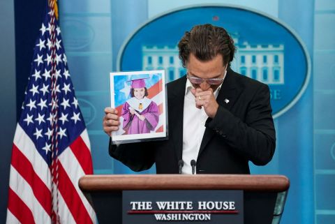 Actor Matthew McConaughey, attending a White House press briefing on Tuesday, June 7, holds up a picture of 10-year-old victim Alithia Ramirez while <a href=