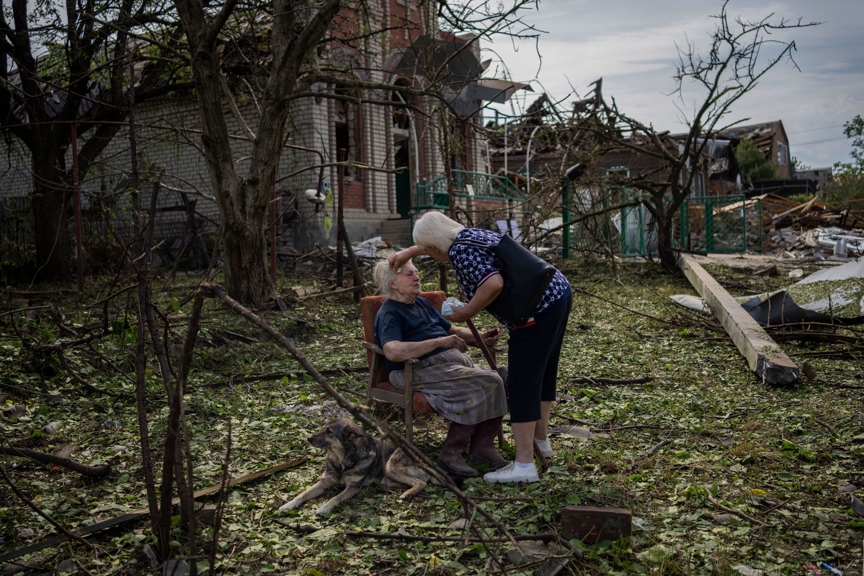 Elena Holovko sits outside her damaged house after a missile strike in Druzhkivka, Ukraine, on Sunday, June 5.