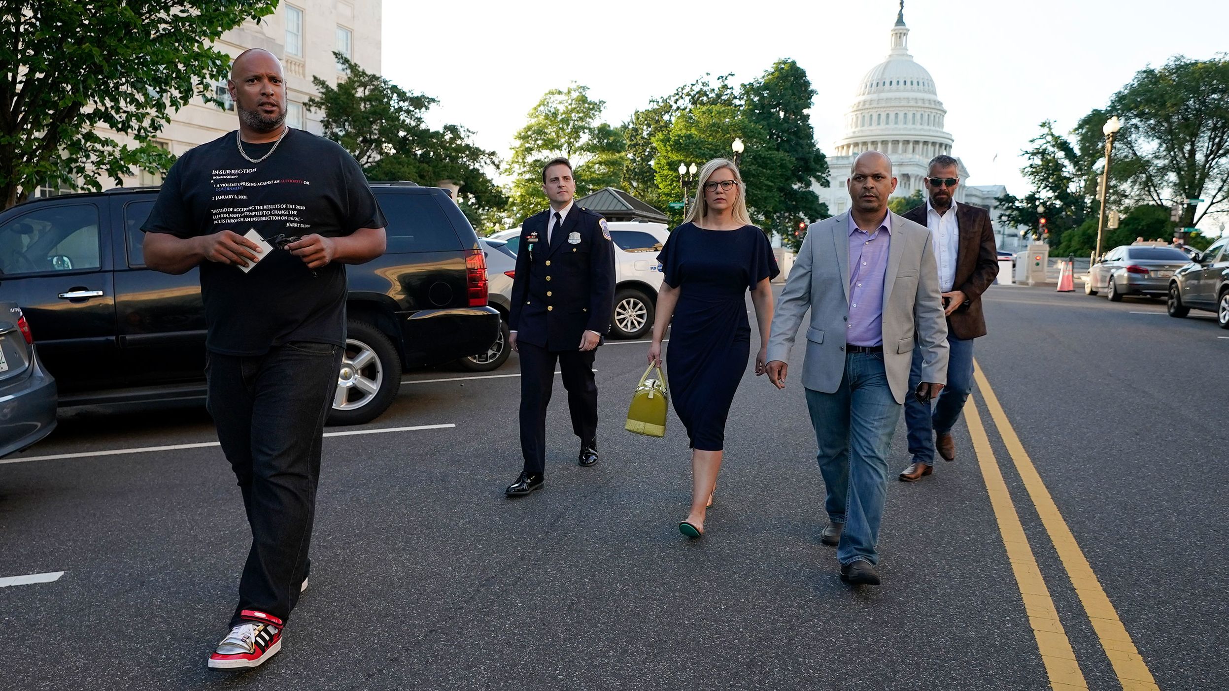 Erin Smith, widow of US Capitol Police officer Jeffrey Smith, walks with some of the men who defended the Capitol on January 6. From left are Capitol Police Harry Dunn, Metropolitan Police Department officer Daniel Hodges, Smith, Capitol Police Sgt. Aquilino Gonell and former Metropolitan Police Department officer Michael Fanone.