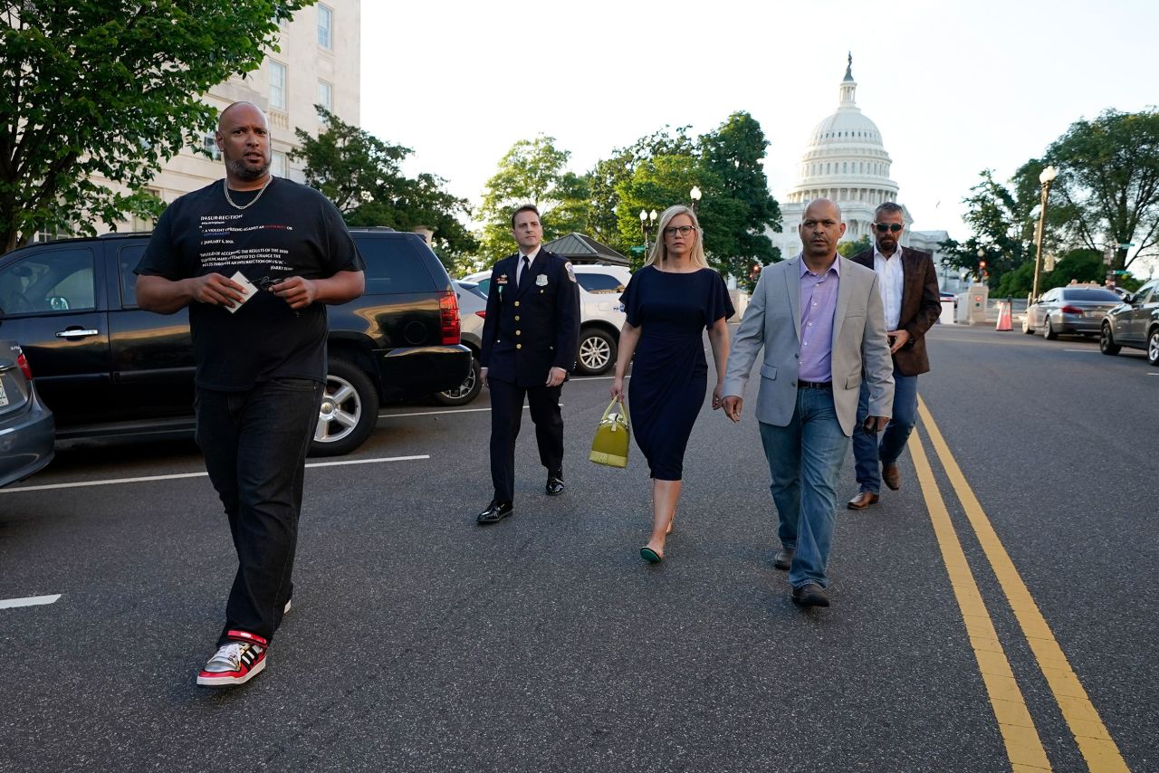 Erin Smith, widow of US Capitol Police officer Jeffrey Smith, walks with some of the men who defended the Capitol on January 6. From left are Capitol Police Harry Dunn, Metropolitan Police Department officer Daniel Hodges, Smith, Capitol Police Sgt. Aquilino Gonell and former Metropolitan Police Department officer Michael Fanone.