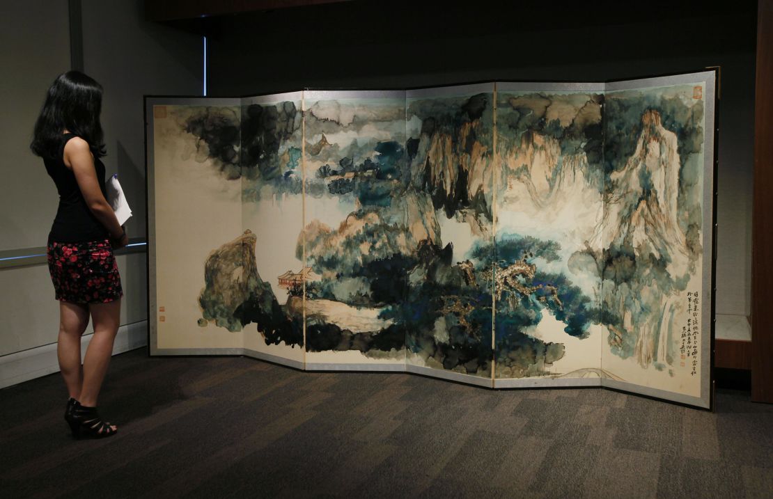 Zhang Daqian's "Recluse in the Summer Mountains" on display at Sotheby's auction house in Hong Kong in 2011. Zhang gave the six-panel screen to his daughter as a wedding gift.