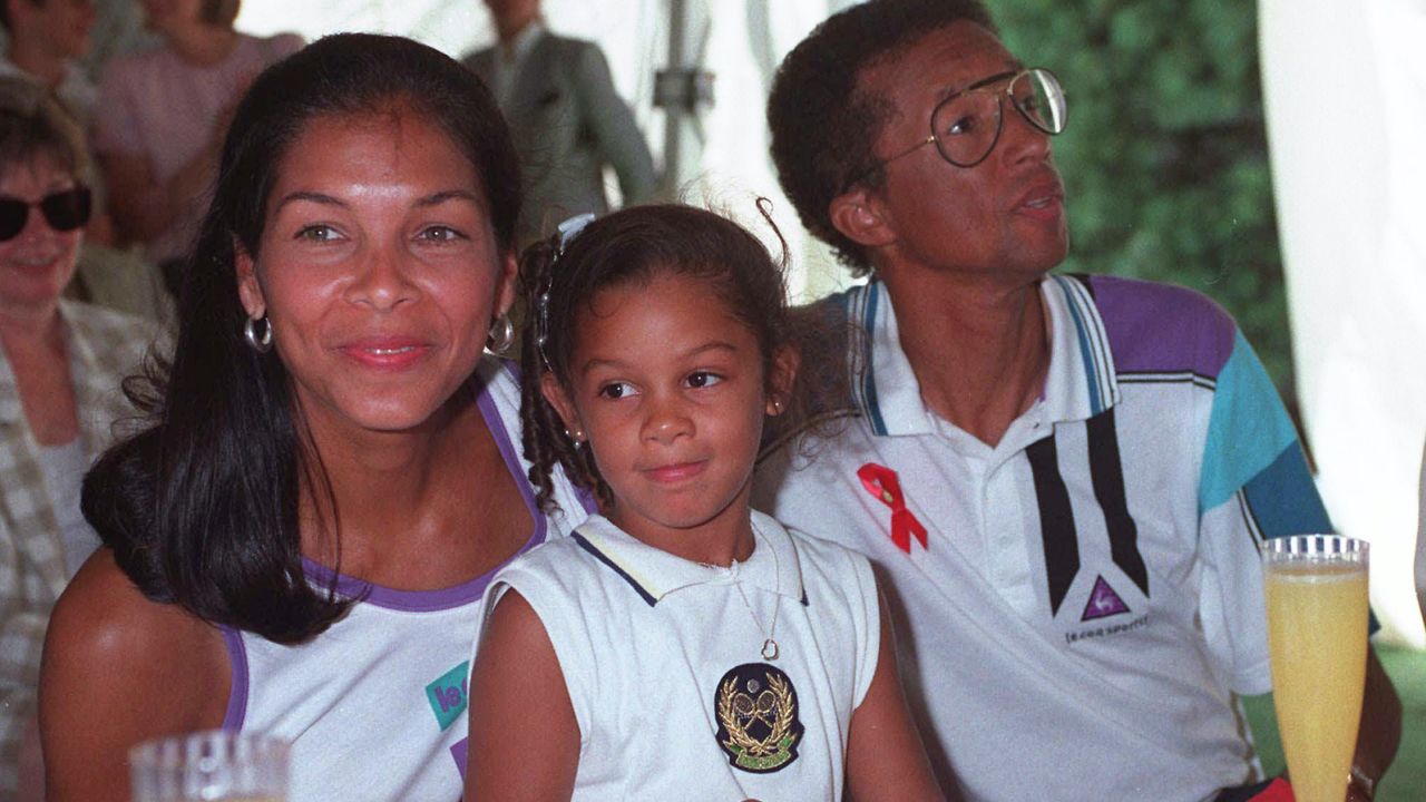 Ashe, right, with wife Jeanie, and Camera, 5, pose during the Arthur Ashe AIDS Tennis Challenge at the USTA National Tennis Center in New York on August 30, 1992. 