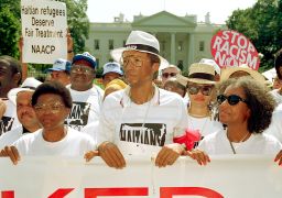 Ashe during a demonstration against the Bush administration's policy on Haiti outside the White House in1992. Ashe was later arrested during the protest sponsored by the NAACP and TransAfrica. 