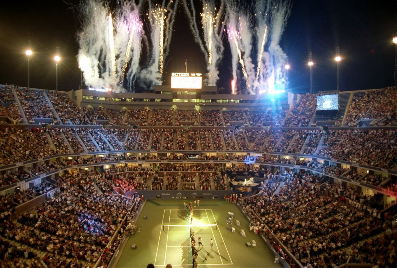 Fireworks are set off during the dedication ceremony for the Arthur Ashe Stadium in New York in 1997. It's the main stadium at Flushing Meadows, which hosts the US Open, and it's the largest tennis stadium in the world. A statue of Ashe is outside.