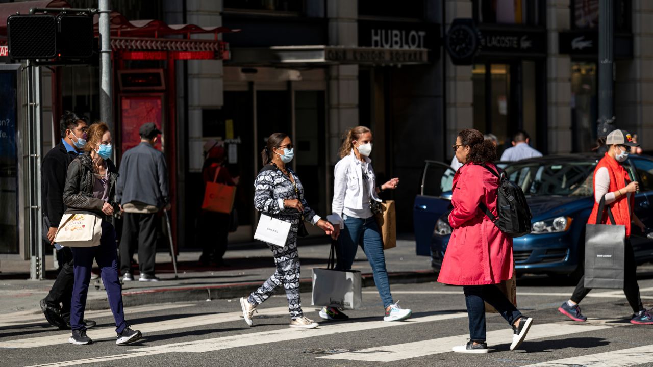 Pedestrians carry shopping bags in San Francisco, California, on Wednesday, June 1, 2022. US consumer sentiment has sunk to its lowest levels on record, according to preliminary data released Friday by the University of Michigan. 