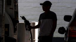 A customer holds a fuel nozzle at a gas station in San Francisco, California, US, on Thursday, June 9, 2022. Stratospheric Fuel prices have broken records for at least seven days with the average cost of fuel per gallon hitting $4.96 as of June 8, according to the American Automobile Association. 