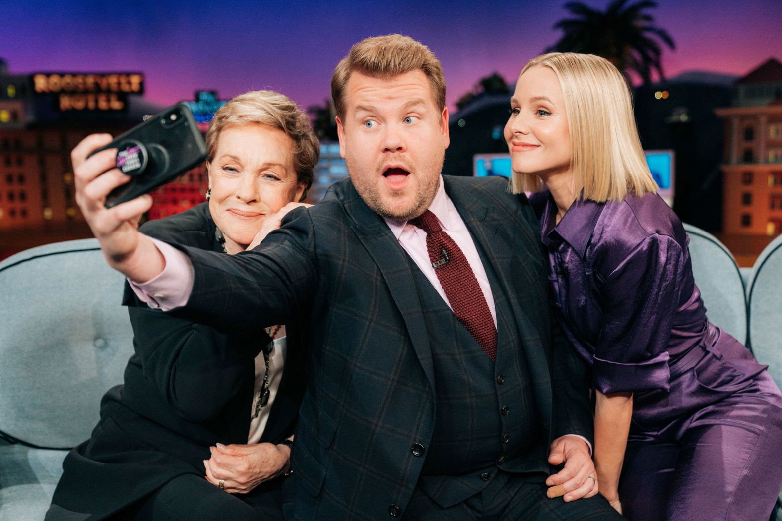 Andrews and Kristen Bell pose for a selfie with late-night host James Corden in 2019.