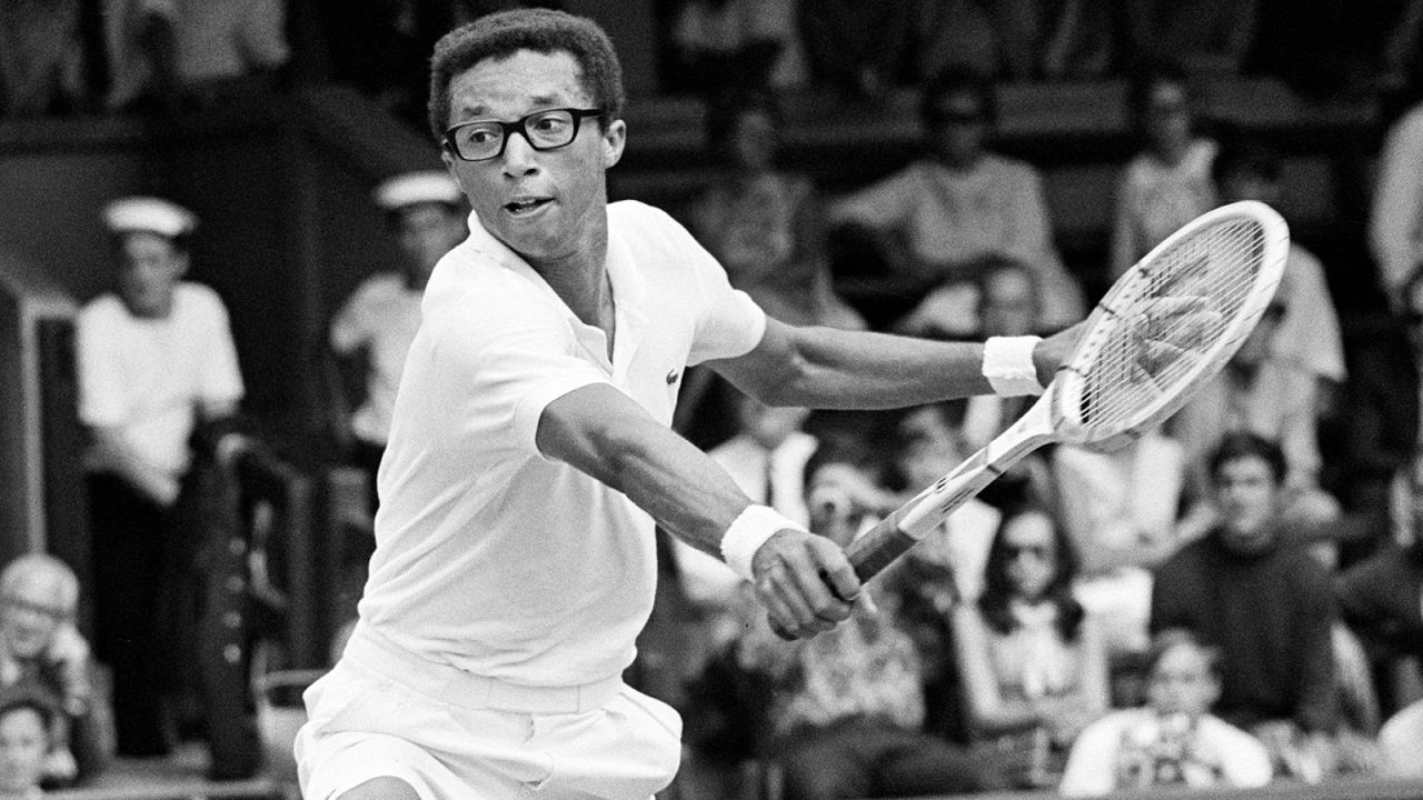 Arthur Ashe hits a shot at Wimbledon in 1969.