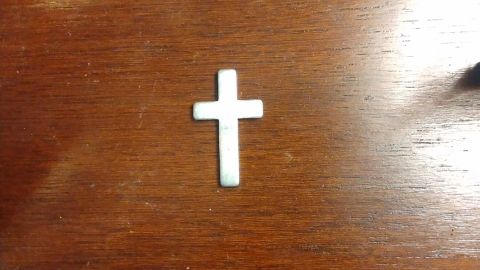 Ashlye Wilkerson keeps this silver cross as a memento from the traffic stop.