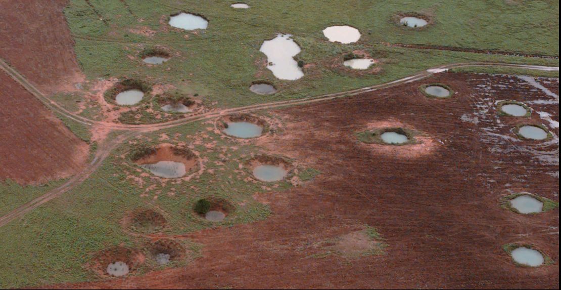 What appear to be ponds are actually water-filled bomb craters from the Vietnam War era, as seen from a helicopter, May 25, 1997, near the northeastern Laotian village of Sam Neau.