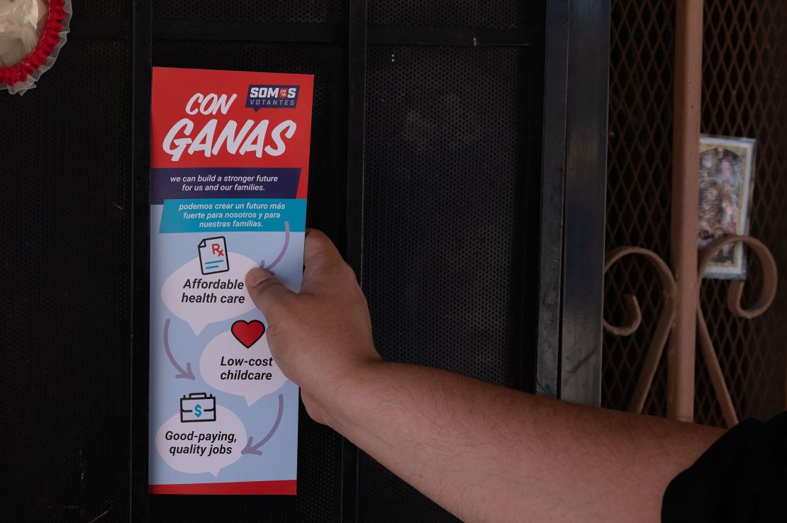 Victor Villanueva of Somos Votantes leaves a flyer behind as he doorknocks in an East Las Vegas neighborhood during the early voting period for Nevada's primary election on June 1, 2022 in Las Vegas, Nevada.