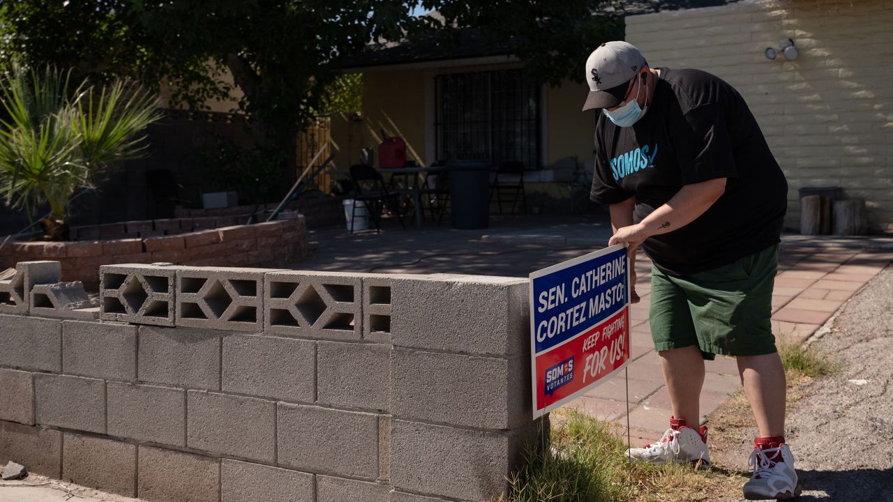 "They are telling me that they are struggling," Villanueva, seen her placeing a sign in the yard of a home in an East Las Vegas neighborhood, says of the people he talks to about rising prices.
