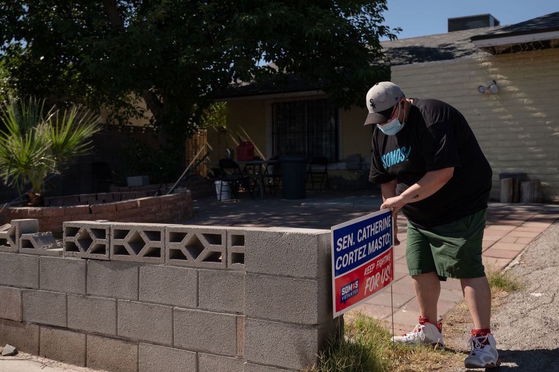 "They are telling me that they are struggling," Villanueva, seen her placeing a sign in the yard of a home in an East Las Vegas neighborhood, says of the people he talks to about rising prices. 
