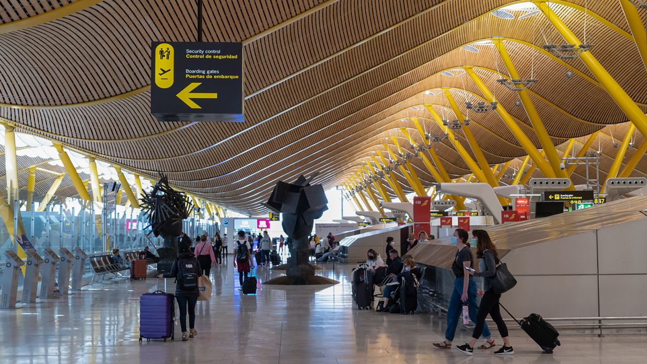 Passengers wait in the departures hall at Madrid Barajas Airport in Spain earlier this year.  (Emilio Parra Doiztua/Bloomberg/Getty Images) 