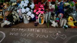 Messages are written in chalk on a sidewalk next to a memorial at Robb Elementary School in Uvalde, Texas, Tuesday, May 31, 2022, to honor the victims killed in last week's school shooting. (AP Photo/Jae C. Hong)