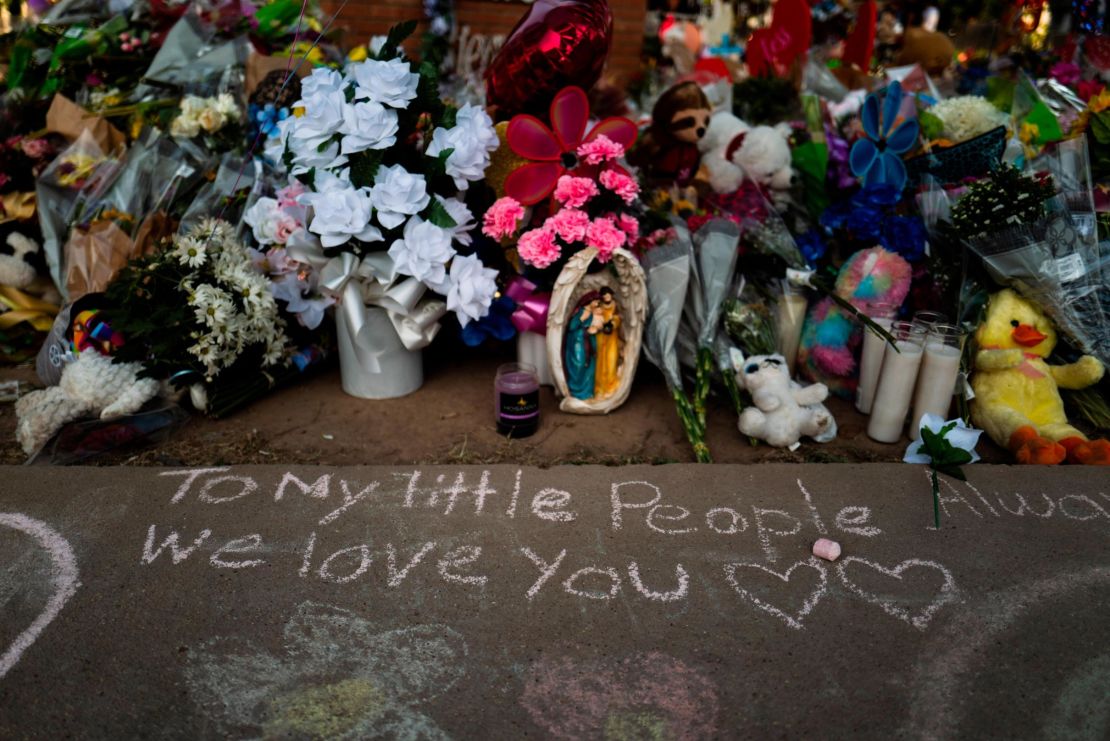 Messages were written in chalk on a sidewalk next to a memorial at Robb Elementary School in Uvalde, Texas, on May 31 to honor the victims killed in the shooting. 