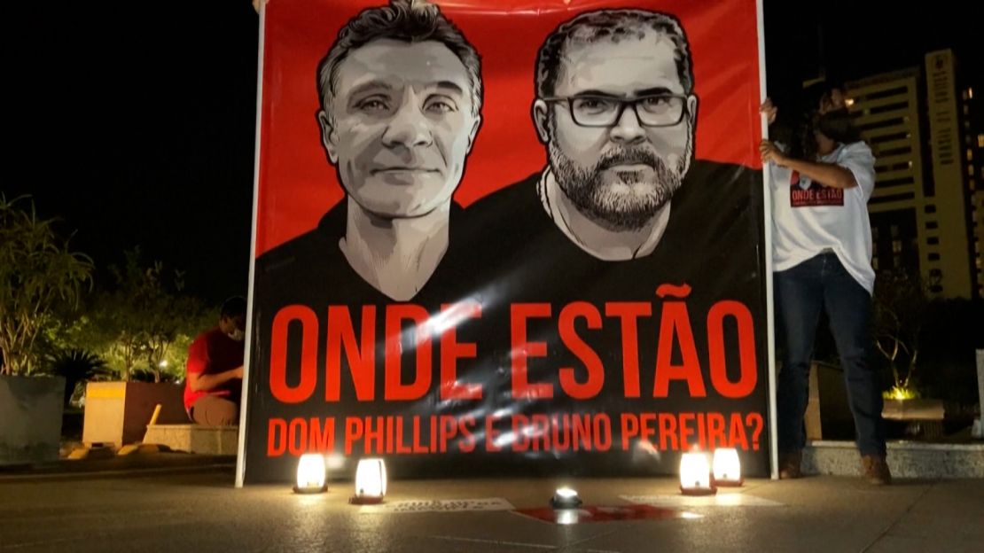 Candles flicker at a vigil for Dom Phillips and Bruno Pereira.