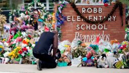 Reggie Daniels pays his respects a memorial at Robb Elementary School, Thursday, June 9, 2022, in Uvalde, Texas, created to honor the victims killed in the recent school shooting. Two teachers and 19 students were killed in the mass shooting. (AP Photo/Eric Gay)