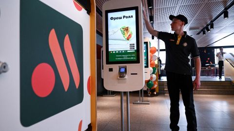 An employee cleans a self-service machine in the Russian version of a former McDonald's restaurant ahead of the opening ceremony, in Moscow.