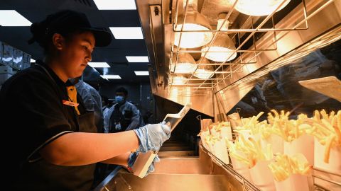 An employee prepares French fries in the Russian version of an old McDonald's restaurant.