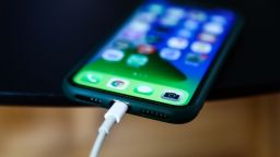 Apple iPhone connected to a Lightning cable is seen in this illustration photo taken in Poland on September 25, 2021.