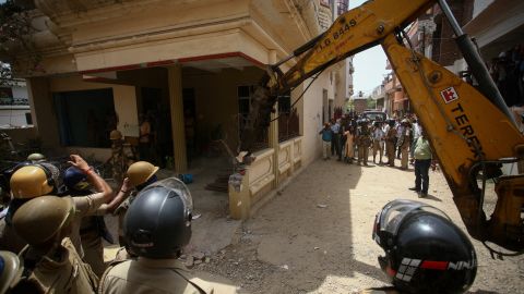 Heavy equipment is used to demolish the house of a Muslim man that Uttar Pradesh state authorities accuse of being involved in riots last week in Prayagraj, India, on June 12.