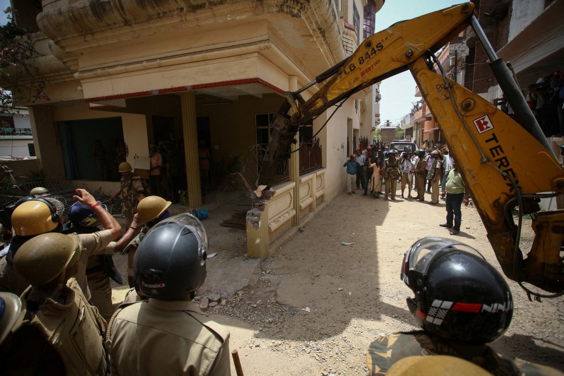 Heavy equipment is used to demolish the house of a Muslim man that Uttar Pradesh state authorities accuse of being involved in riots last week in Prayagraj, India, on June 12.