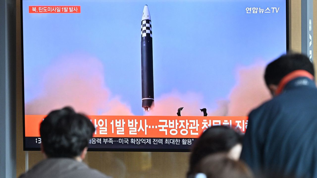 People in Seoul watch a news broadcast showing footage of a North Korean missile test. 