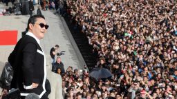 South Korean rapper Park Jae-Sang also known as Psy performs "Gangnam Style" in front of a crowd during a flashmob on November 5, 2012 in Paris.  The video to "Gangnam Style" went viral after its July release, becoming the second most viewed clip in YouTube history, where it has notched up more than 650 million hits despite being sung almost entirely in Korean. AFP PHOTO / THOMAS SAMSON        (Photo credit should read THOMAS SAMSON/AFP via Getty Images)