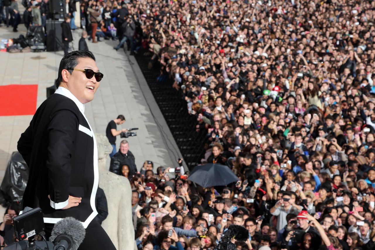 South Korean rapper Park Jae-Sang also known as Psy performs "Gangnam Style" in front of a crowd during a flashmob on November 5, 2012 in Paris.