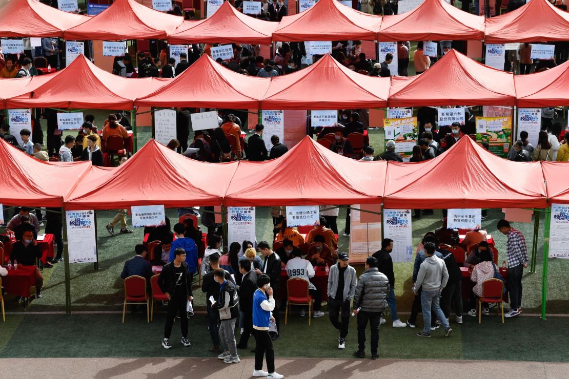 Students look for job during a campus job fair in Xining, northwest China's Qinghai Province, March 24, 2022. 