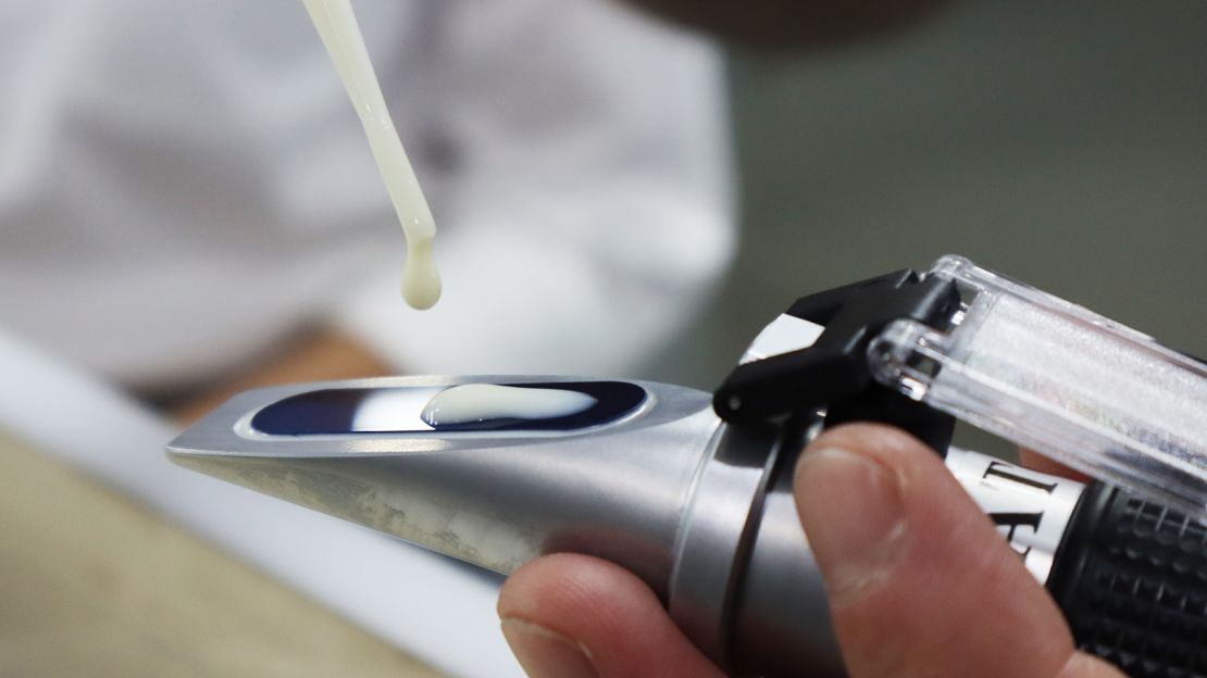 Modern tofu-making: A reflector is used to check the thickness of the soy milk.