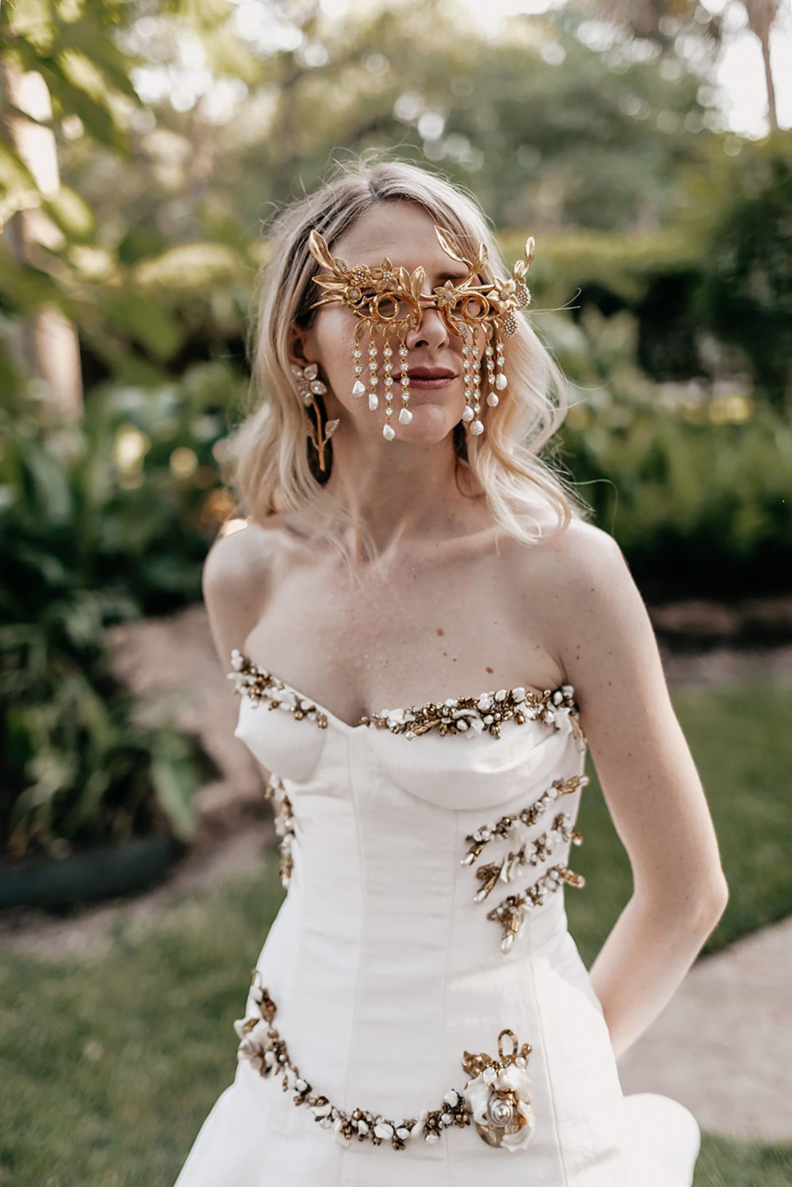 Schiaparelli's creative director Daniel Roseberry designed a dress for his sister Liz to wear at her wedding, adding a touch of his signature surreal style with these glasses.