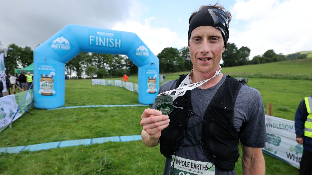 Ricky Lightfoot stands with his medal after claiming victory.