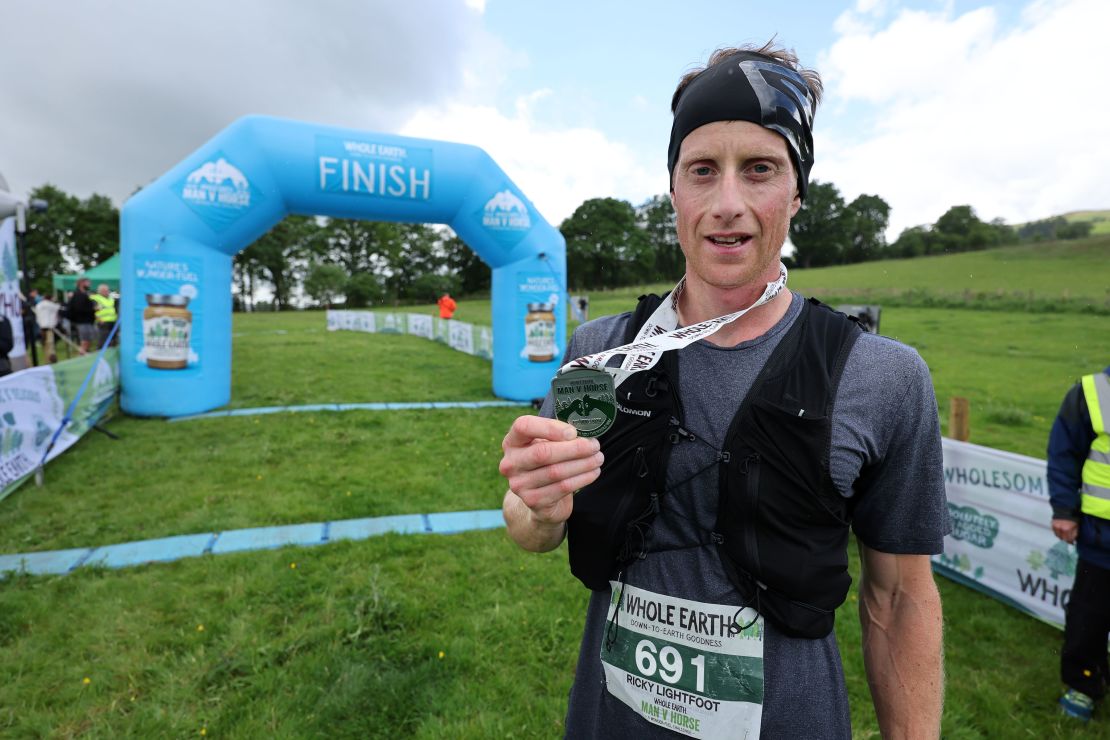 Ricky Lightfoot stands with his medal after claiming victory.