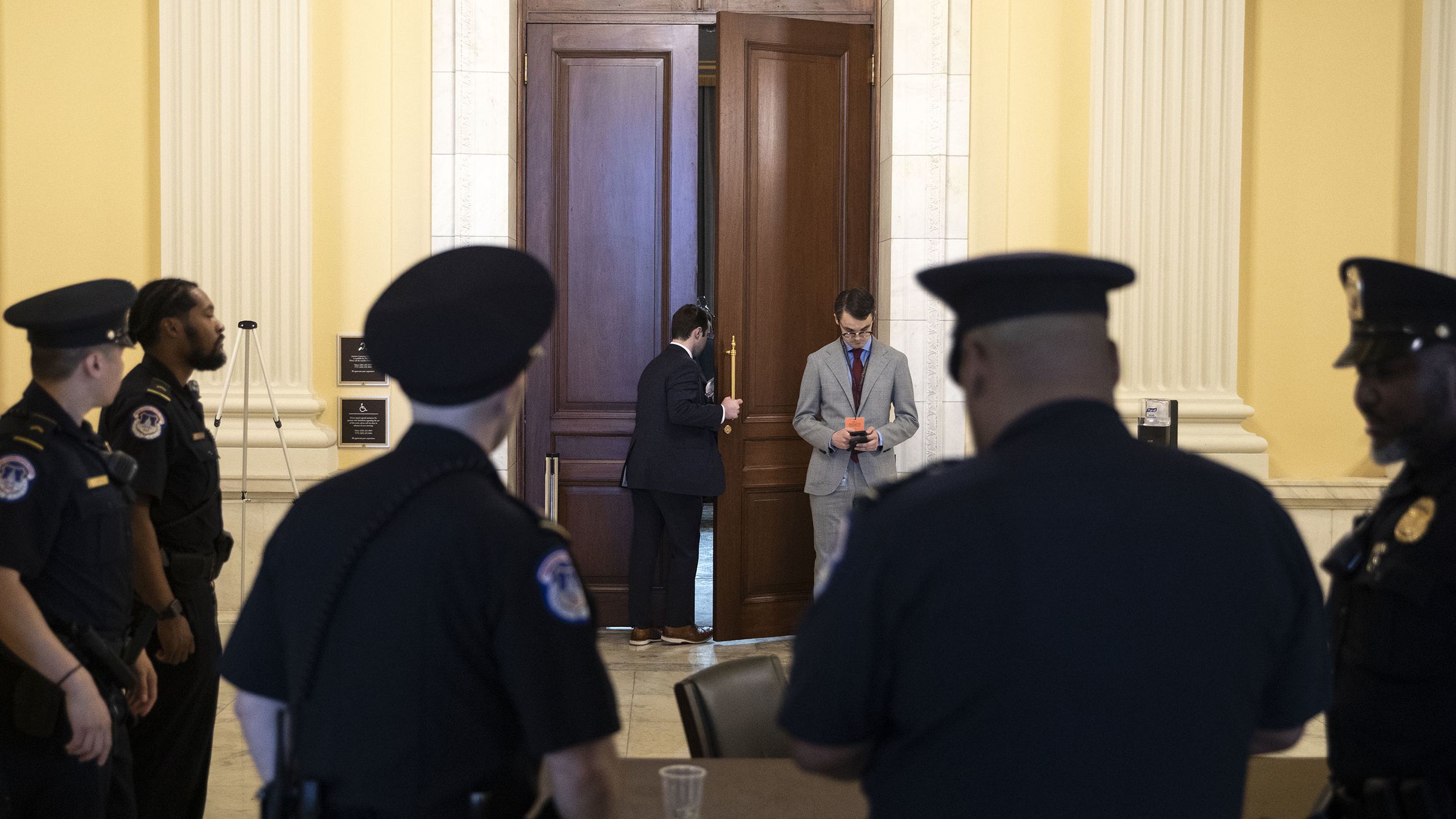 A staff member looks into the hearing room on June 13.