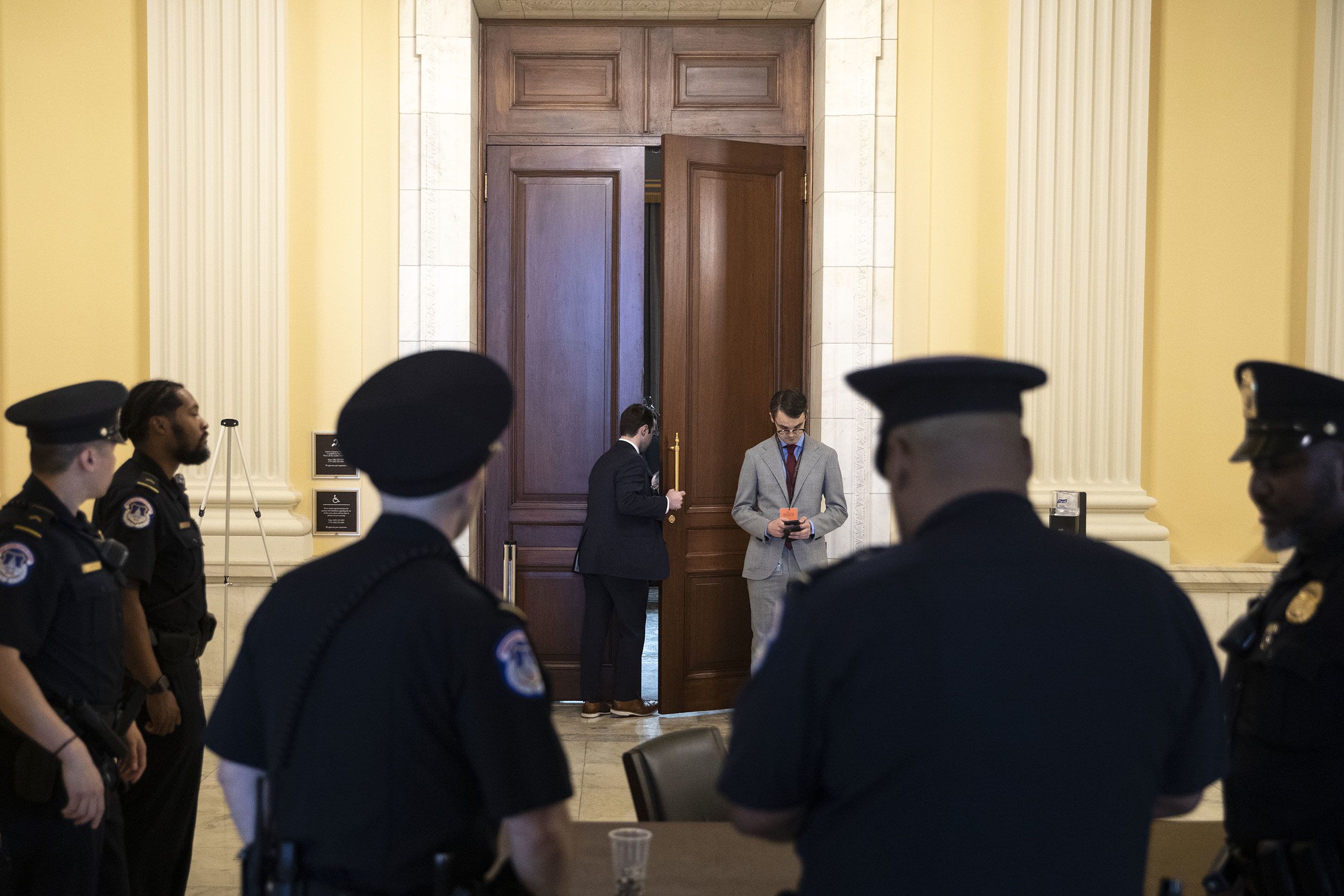 A staff member looks into the hearing room on June 13.